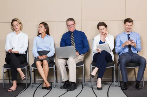 Against-the-queue: Photo of a group of people waiting at a consulate queue