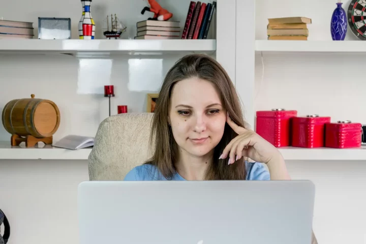 Can I become an Italian citizen: photo of a woman in front of a computer wondering about Italian citizenship eligibility