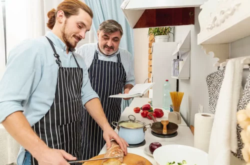 The philosophy of cucina povera in Italian cuisine: Photo of father and son cooking together