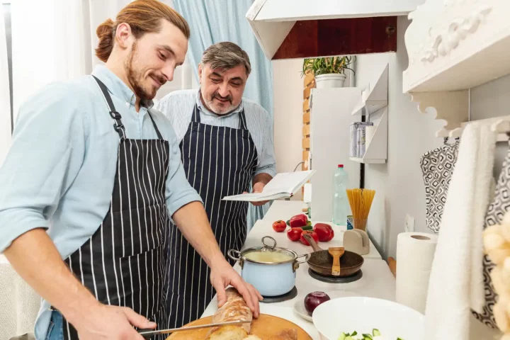 The philosophy of cucina povera in Italian cuisine: Photo of father and son cooking together