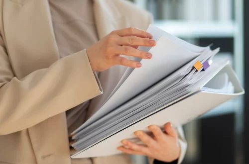 Person holding a pile of documents for italian citizenship