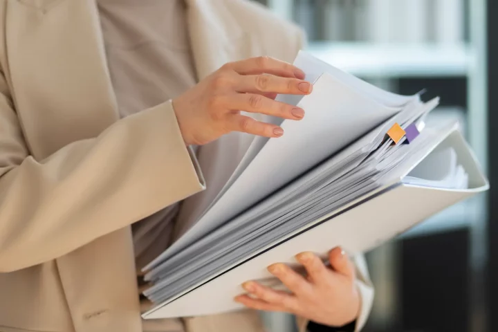 Person holding a pile of documents for italian citizenship