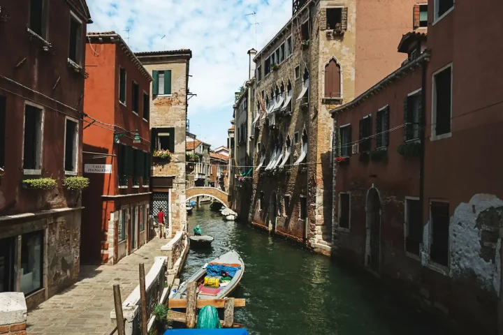 How can I get permanent residency in Italy: Photo of traditional italian houses in the city canals of Venice