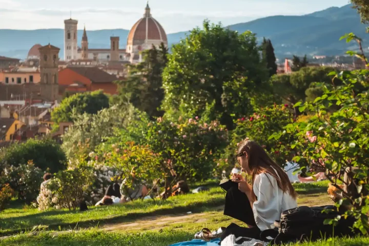 The Italian language: Photo of a woman in florence writing notes in a park
