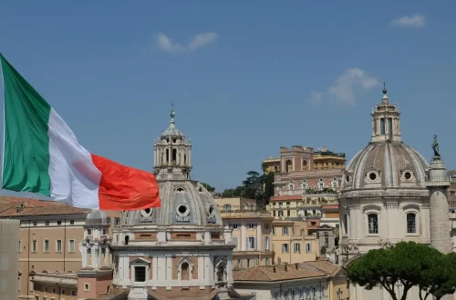 Breaking down Italian stereotypes: Photo of the Italian flag and renaissance era buildings