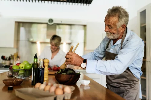 The power of regional identity in Italian Cuisine: Photo of an elderly couple preparing a dish