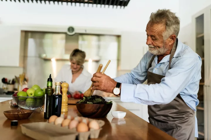 The power of regional identity in Italian Cuisine: Photo of an elderly couple preparing a dish