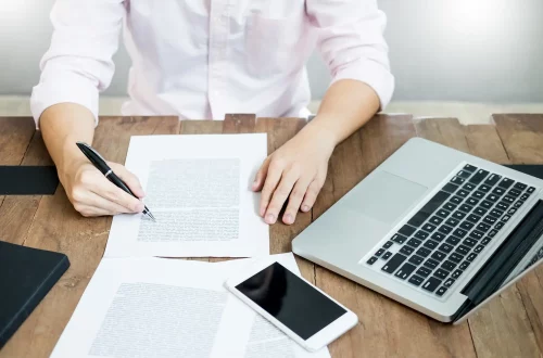 Person on desk working on translation for Italian citizenship documents