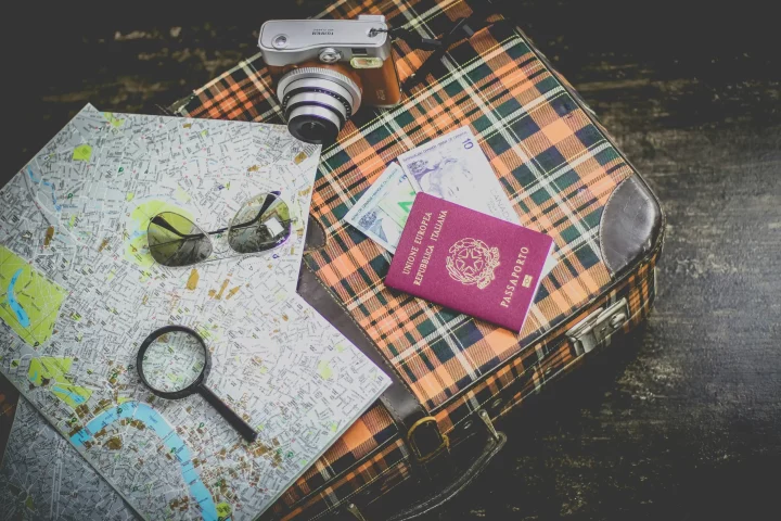 Photo of maps, luggage and a italian passport