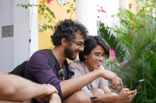 photo of two people looking up on the cellphone what is Aire